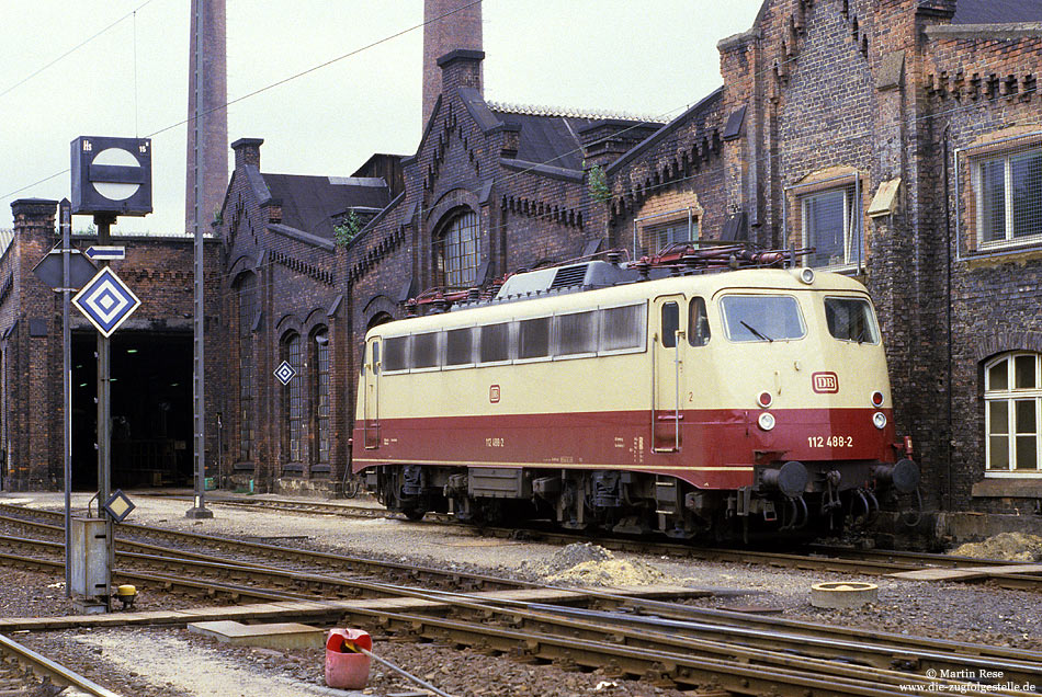 112 488 im Bw Kassel mit Lokschuppen und Form-Sperrsignal