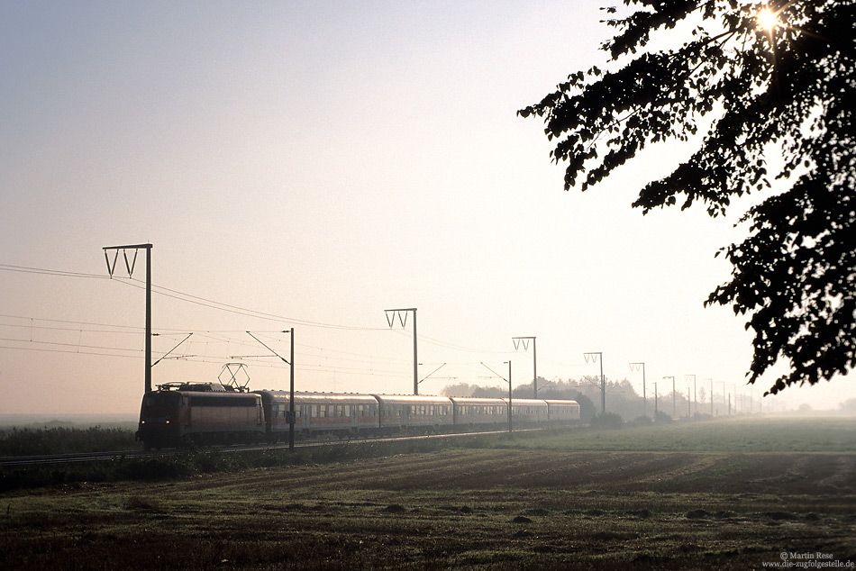 Am frühen Morgen des 5.9.2002 fährt die 110 374 mit dem RE24040 aus Hannover  bei Oldersum seinem Ziel Emden entgegen.